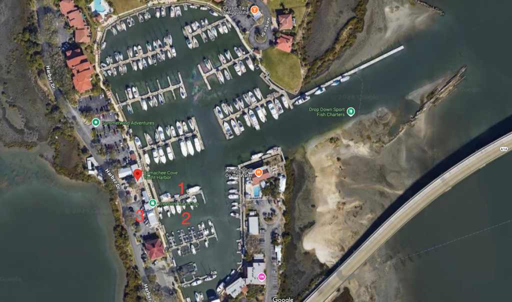 Aerial view of Camachee Cove Yacht Harbor in St. Augustine, Florida, highlighting key locations for Freedom Boat Club members. The number 1 indicates where boats should be returned, number 2 marks the location to take boats out, and number 3 shows the designated parking area.